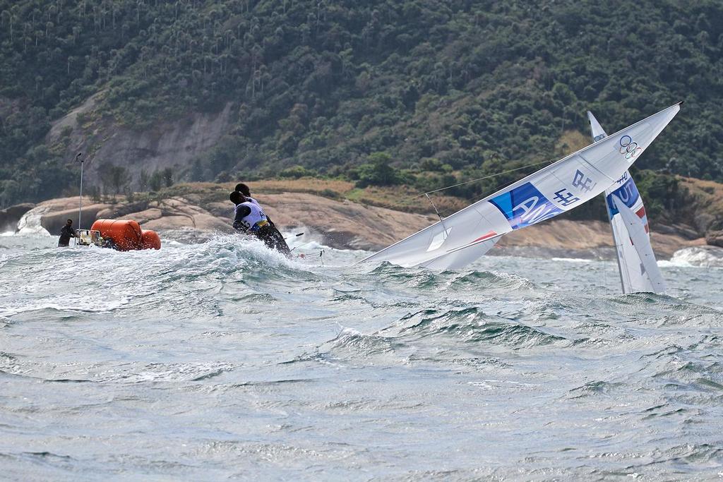 An Angola crew capsize before the start of Race 3, 2016 Olympic regatta sailed in 3-4 metre waves and 20kt winds © Richard Gladwell www.photosport.co.nz